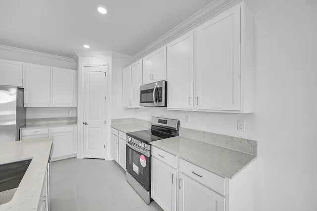 a kitchen with stainless steel appliances granite countertop a sink and a stove