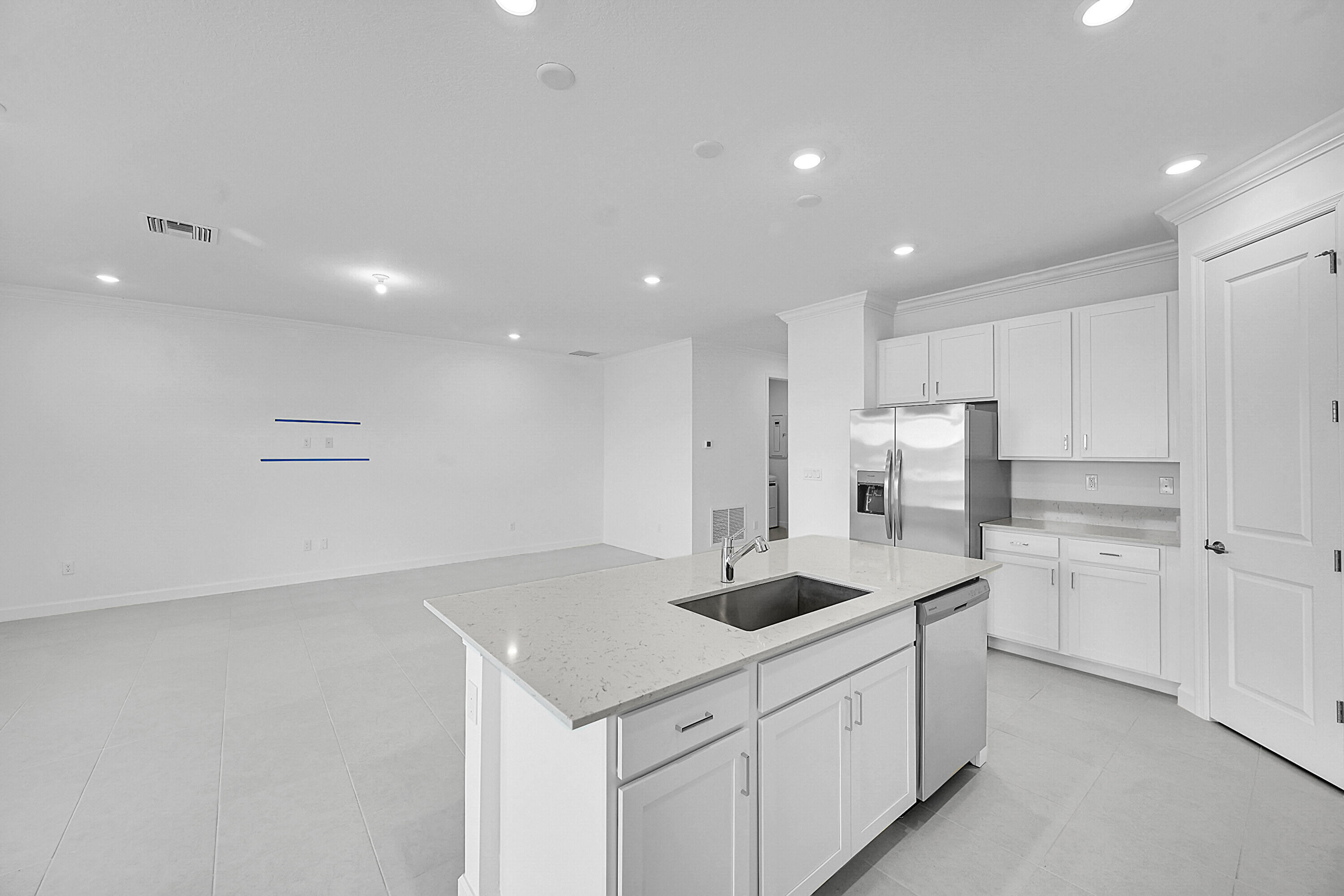 3532 Angler Drive Fort Pierce, FL 34946 - Photo 22 of 31 a kitchen with stainless steel appliances a sink a stove a refrigerator and white cabinets