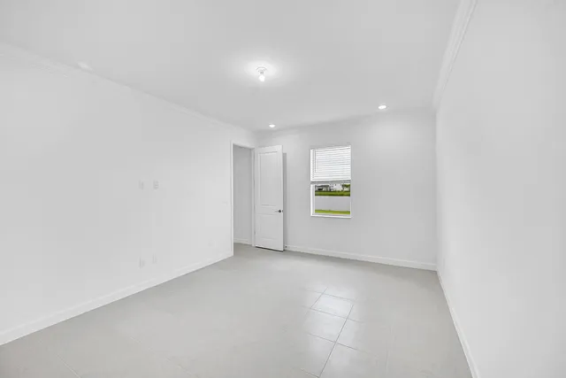 a view of an empty room with a window