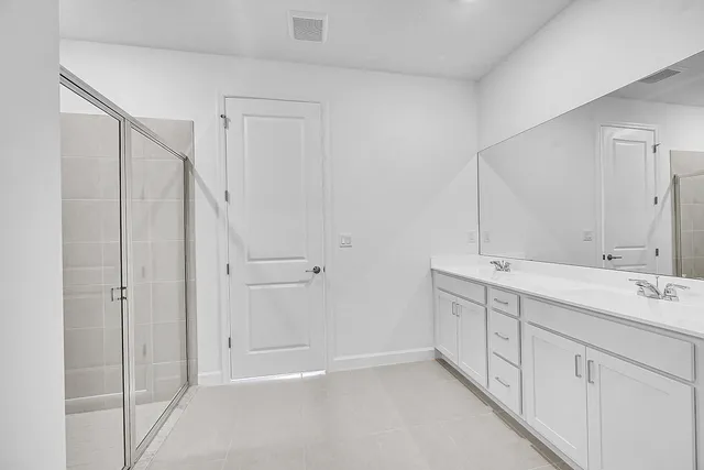 a bathroom with a double vanity sink and mirror
