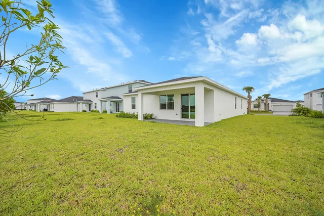 a view of an house with backyard space and balcony