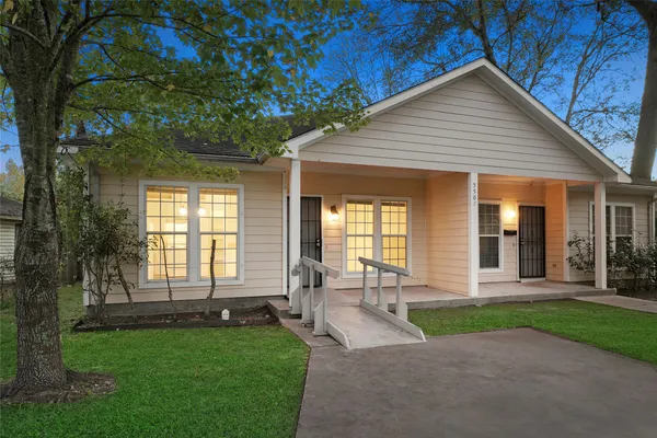 a front view of a house with a yard and outdoor seating