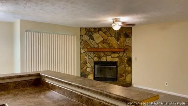 a view of a livingroom with a fireplace and window