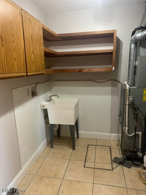 8136 Bellflower Road Mentor, OH 44060 - Photo 6 of 17 Laundry area with light tile patterned floors, cabinet space, hookup for a washing machine, and heating unit
