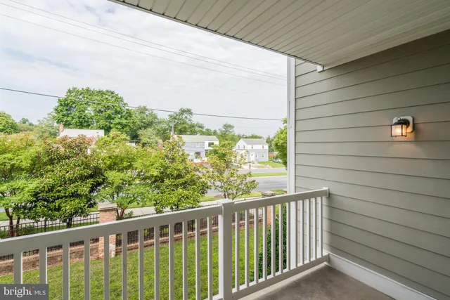 a view of a balcony with flower plants