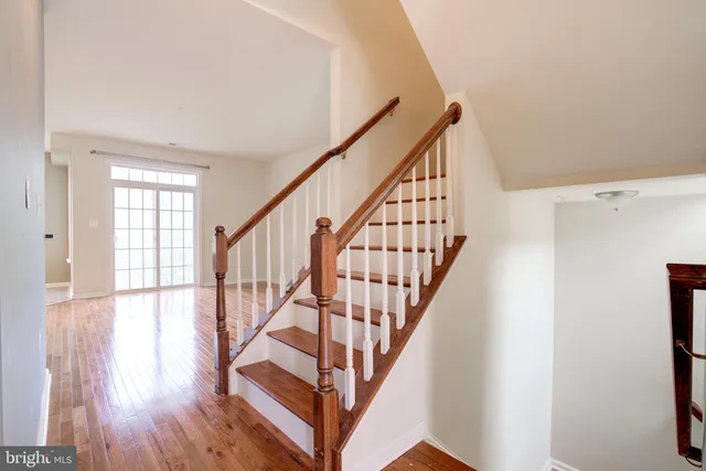 a view of entryway with wooden floor and stairs
