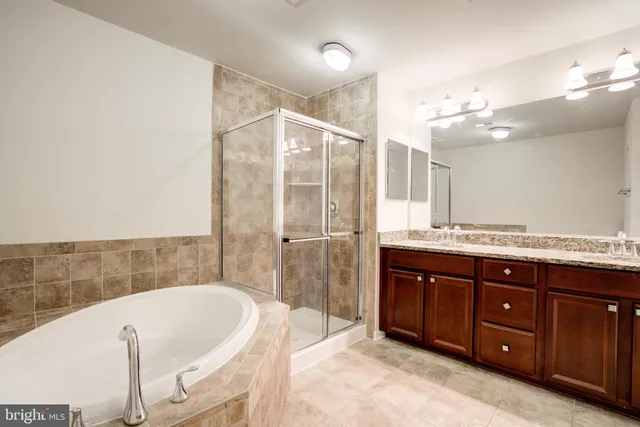 a large spacious bathroom with a tub shower and sink