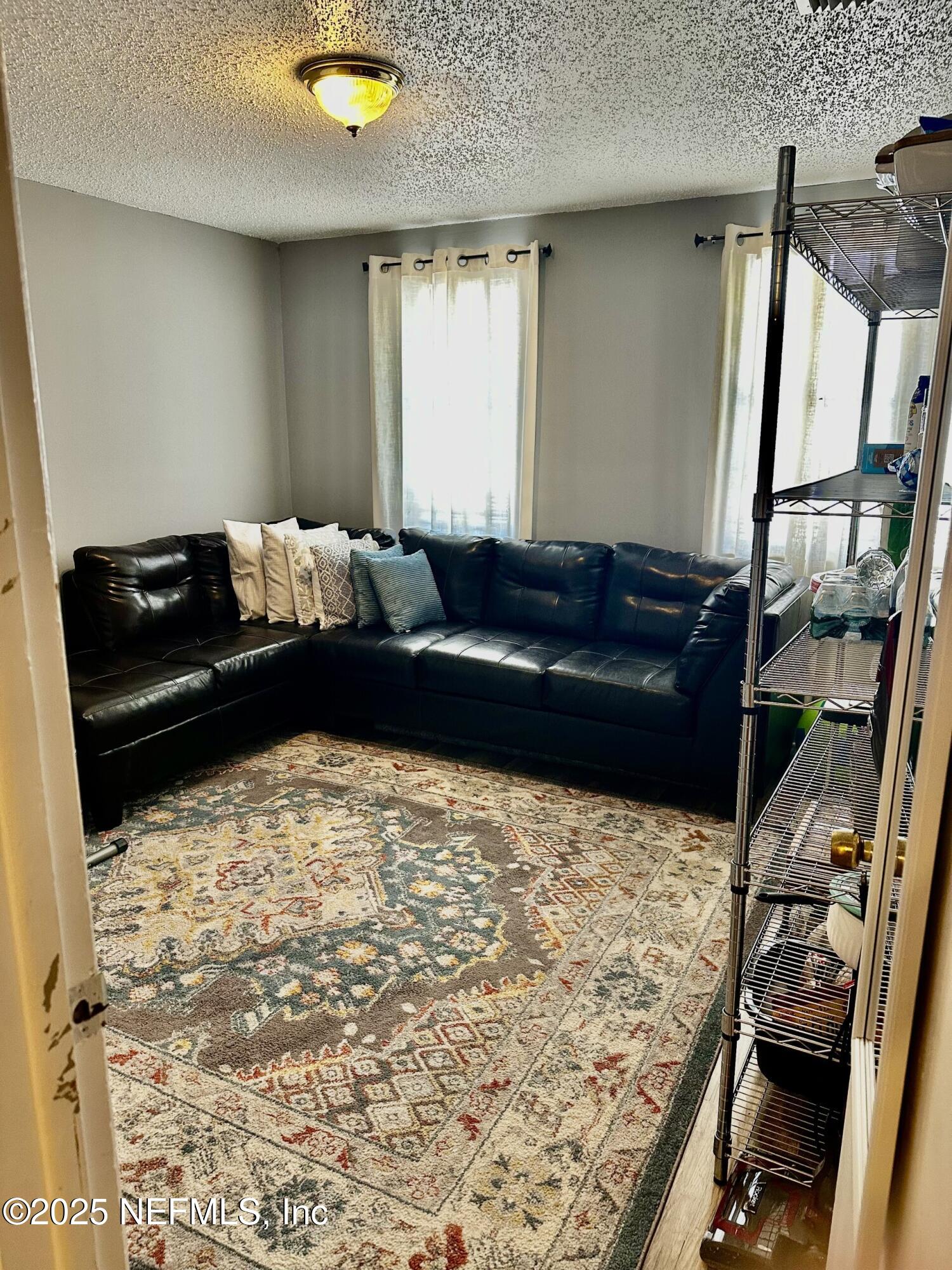 1540 El Prado Road, Unit 3 Jacksonville, FL 32216 - Photo 11 of 26 a living room with a couch and a stove next to a window