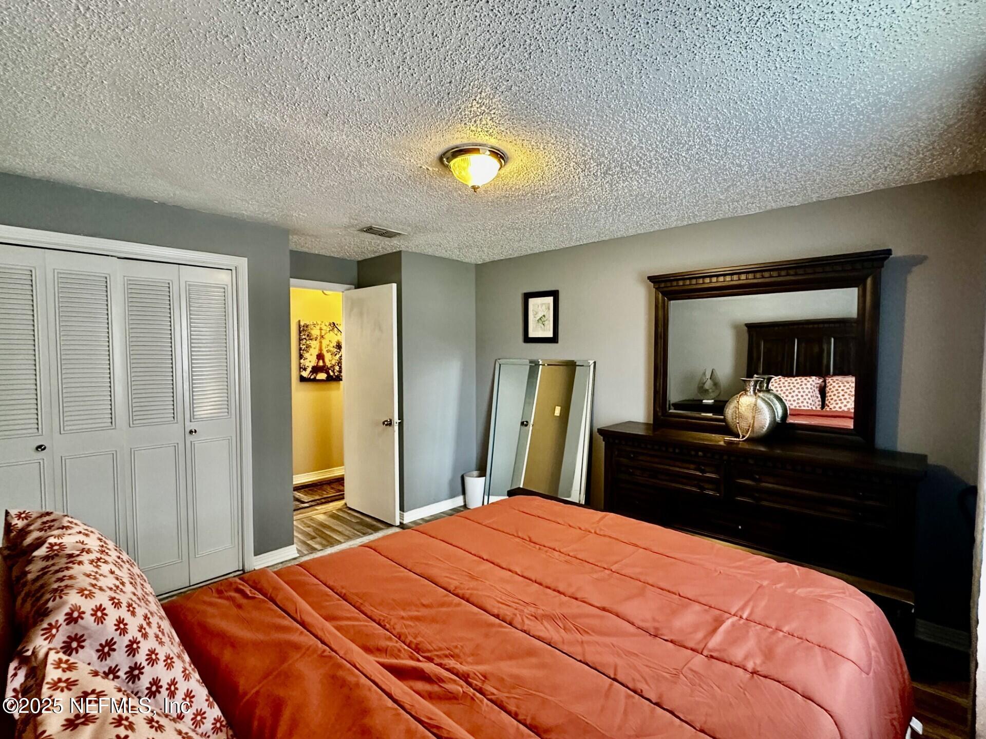 1540 El Prado Road, Unit 3 Jacksonville, FL 32216 - Photo 13 of 26 a bedroom with a bed and a dresser