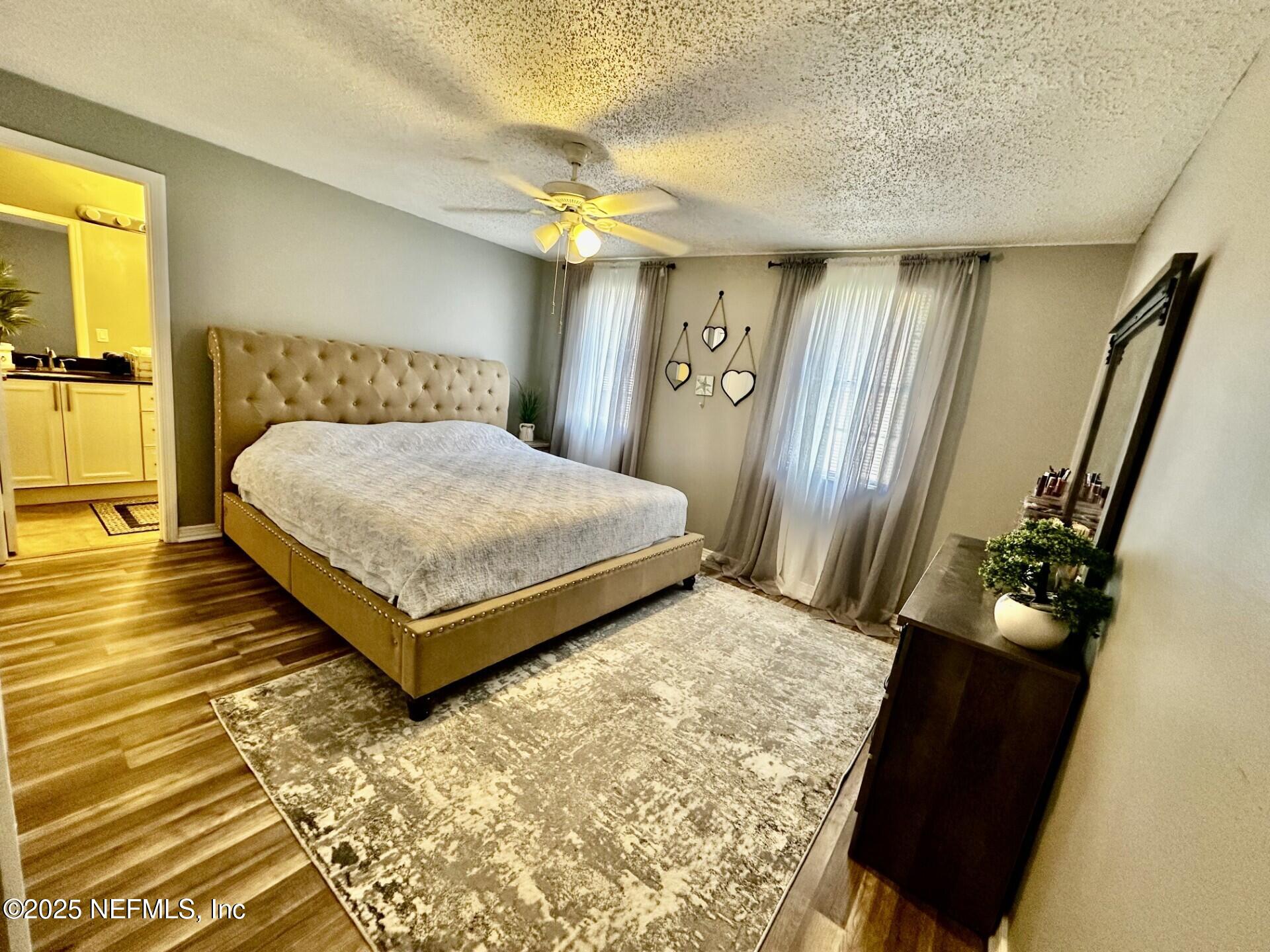 1540 El Prado Road, Unit 3 Jacksonville, FL 32216 - Photo 15 of 26 a bedroom with a bed and wooden floor