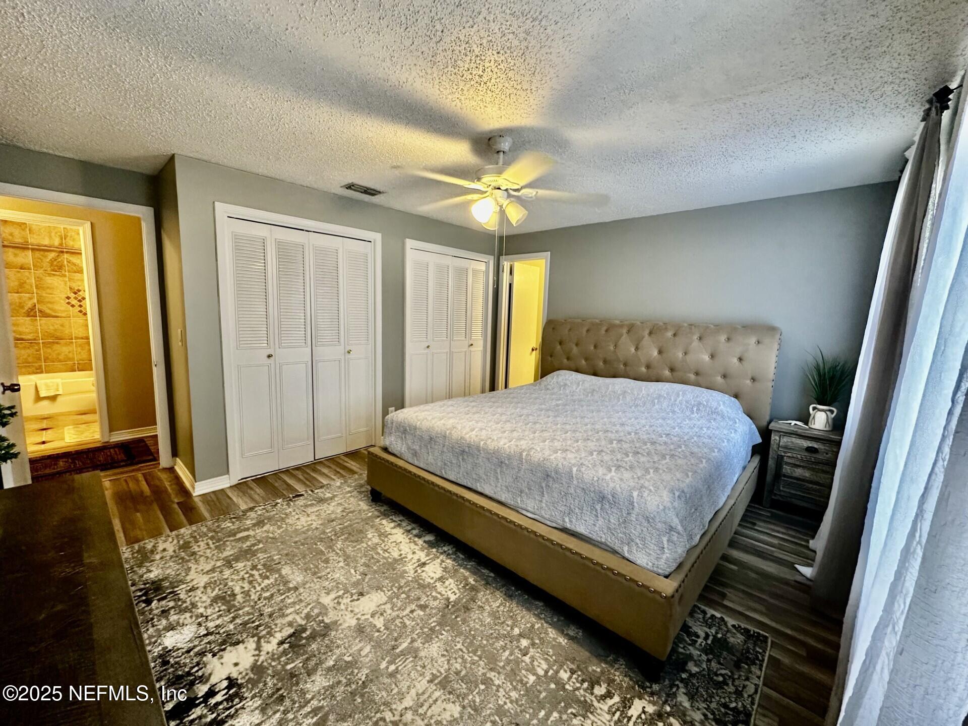 1540 El Prado Road, Unit 3 Jacksonville, FL 32216 - Photo 16 of 26 a bedroom with a bed and a chandelier