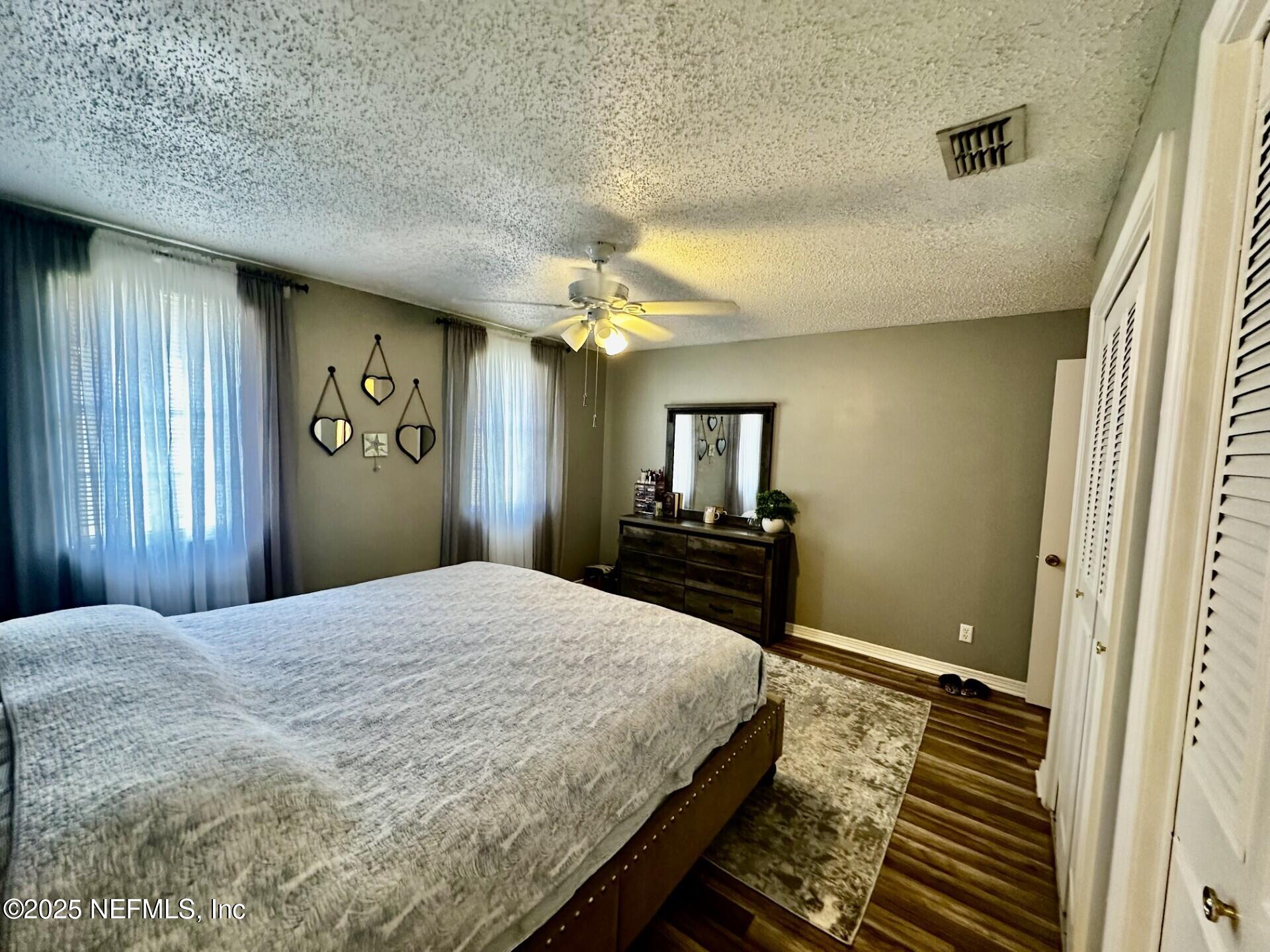 1540 El Prado Road, Unit 3 Jacksonville, FL 32216 - Photo 17 of 26 a bedroom with a bed and a chandelier