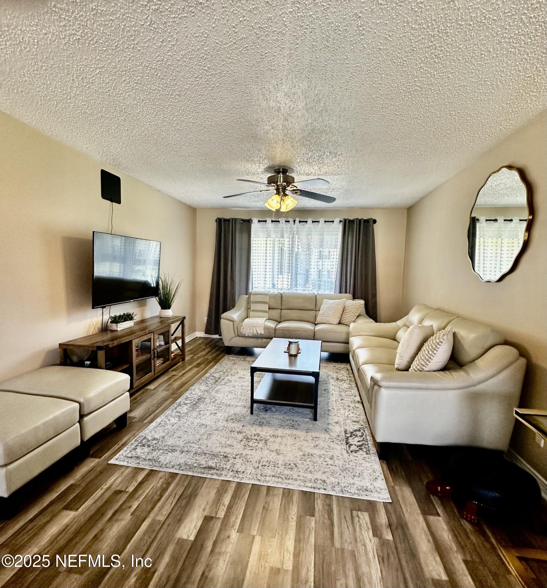 1540 El Prado Road, Unit 3 Jacksonville, FL 32216 - Photo 6 of 26 a living room with furniture and a flat screen tv