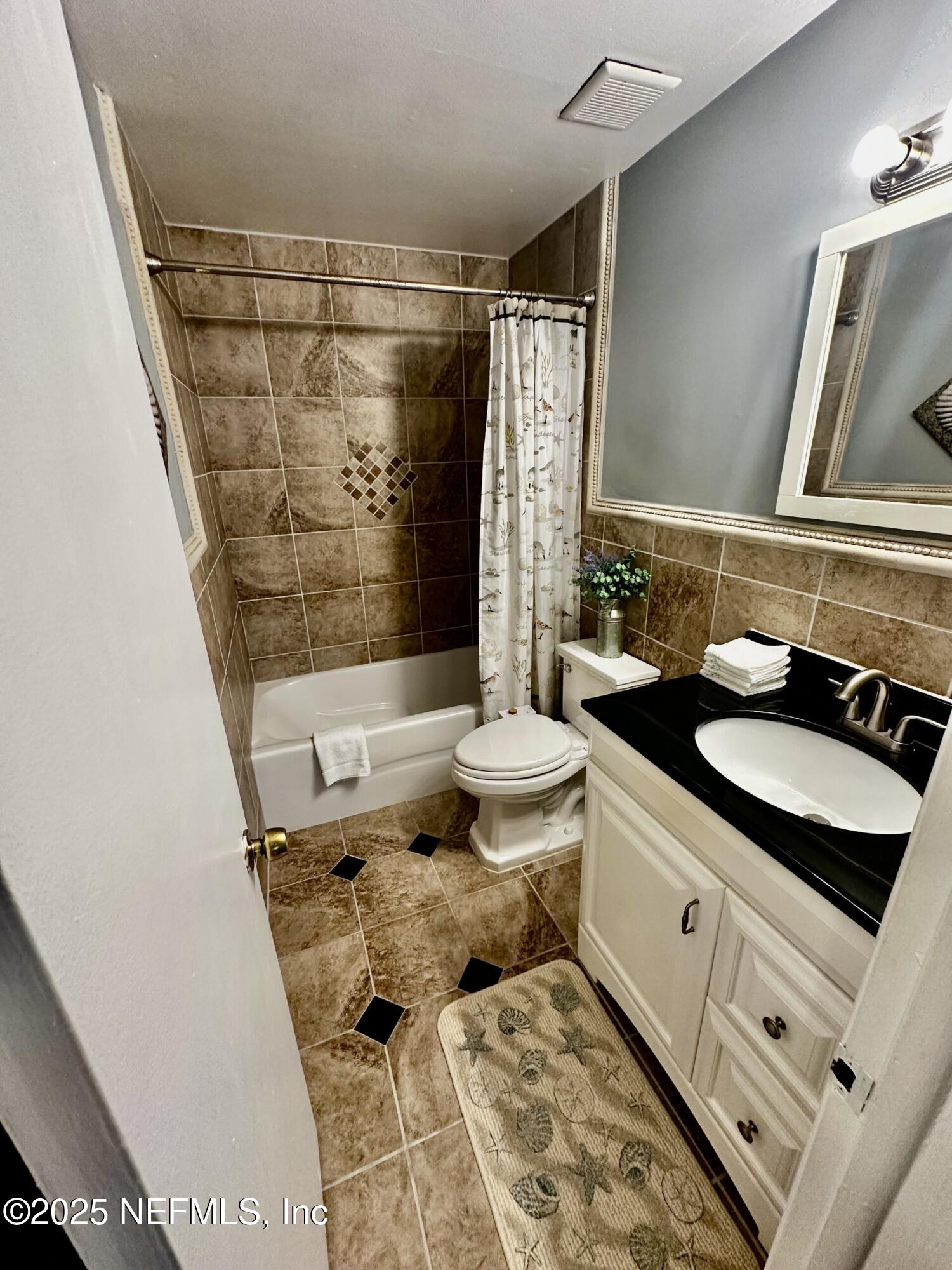 1540 El Prado Road, Unit 3 Jacksonville, FL 32216 - Photo 8 of 26 a bathroom with a sink and a mirror