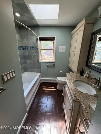 a bathroom with a sink a mirror and a bathtub