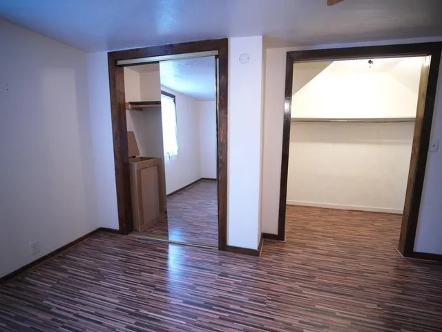 a view of a room with wooden floor and closet