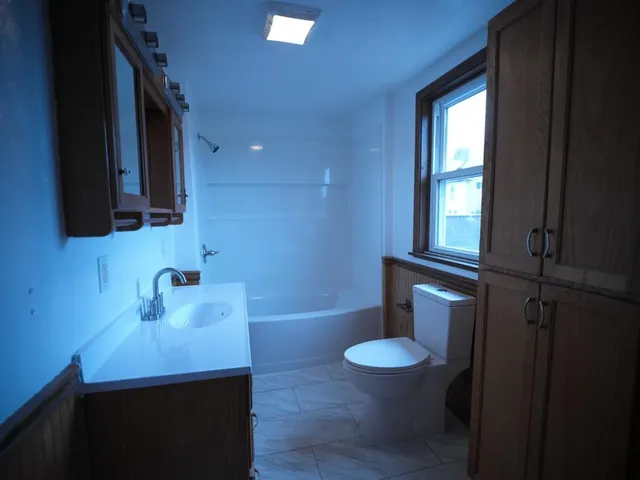a bathroom with a sink a toilet and tub