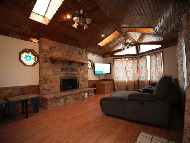 a living room with furniture a fireplace and a flat screen tv