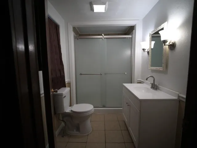 a bathroom with a sink toilet and shower