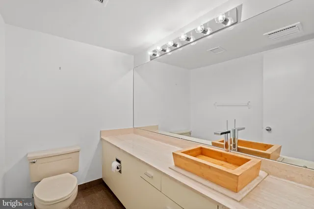 a bathroom with a sink a toilet and vanity