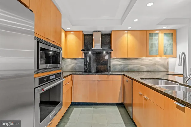 a kitchen with stainless steel appliances a stove sink and microwave