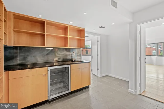 a kitchen with stainless steel appliances granite countertop a stove and a refrigerator
