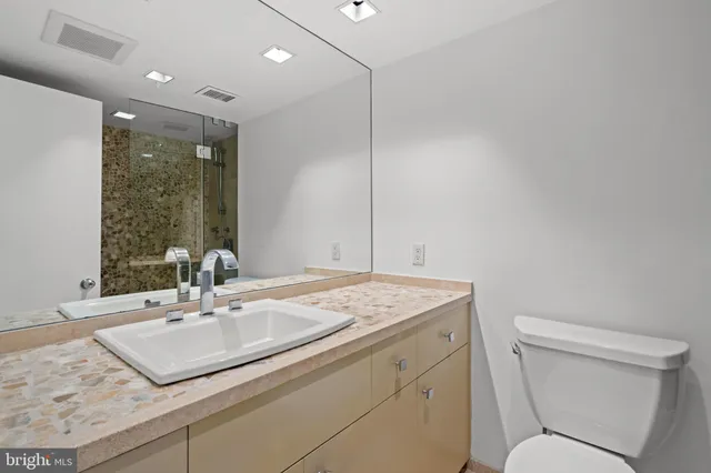 a bathroom with a sink toilet and vanity