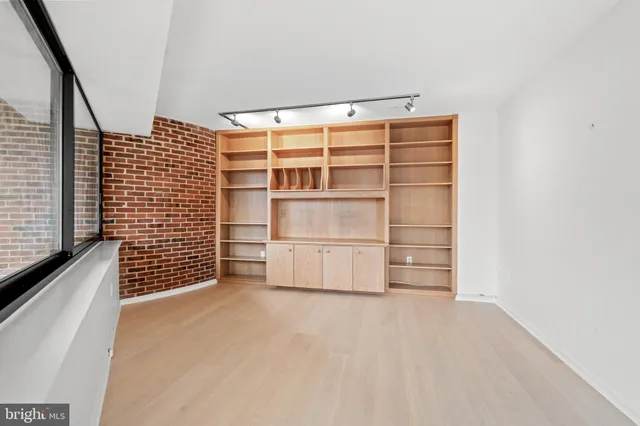 a view of walk in closet with empty racks