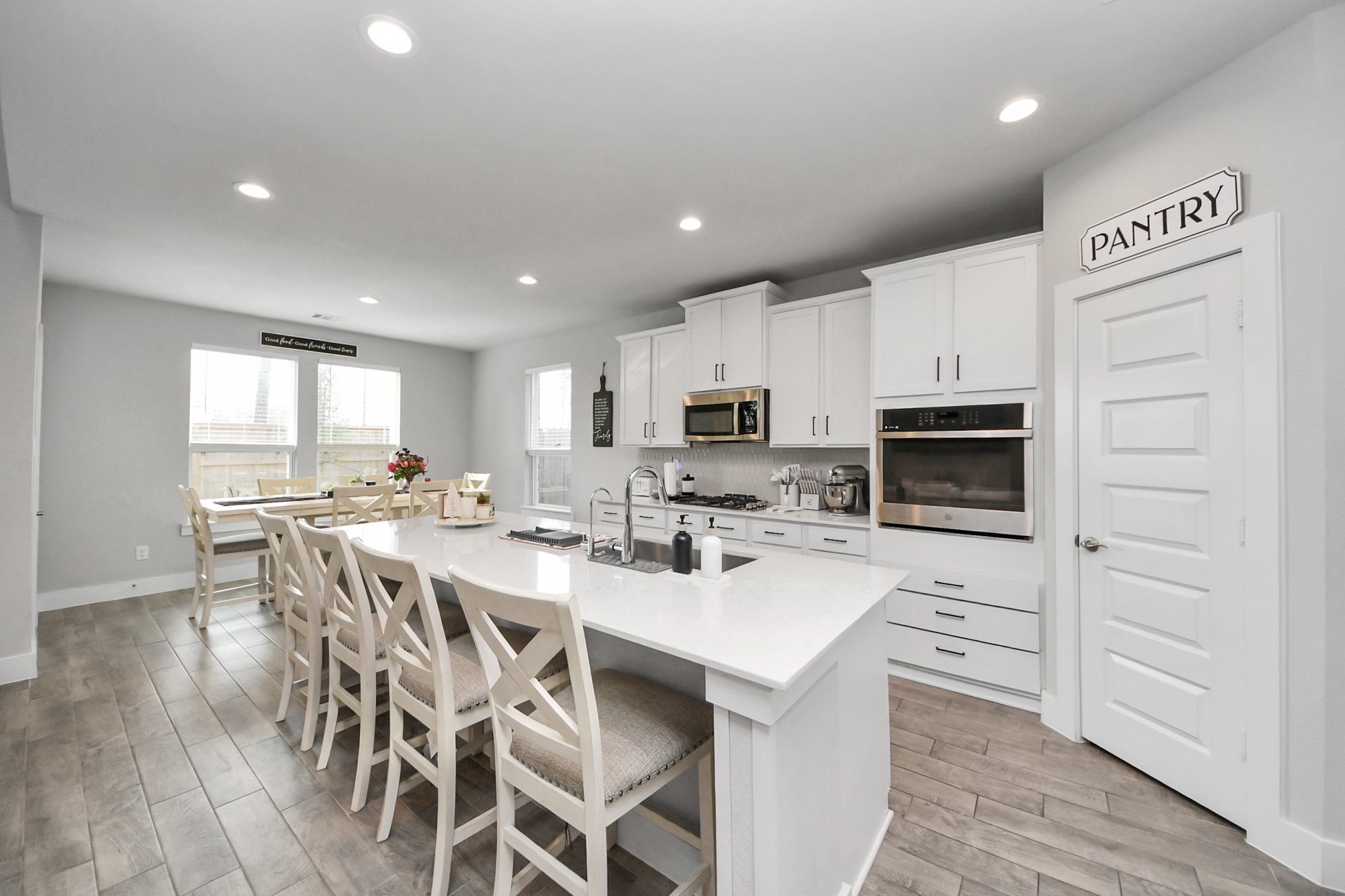 1920 Golden Spruce Lane Conroe, TX 77301 - Photo 12 of 28 a kitchen with stainless steel appliances kitchen island granite countertop a stove a sink a dining table and chairs
