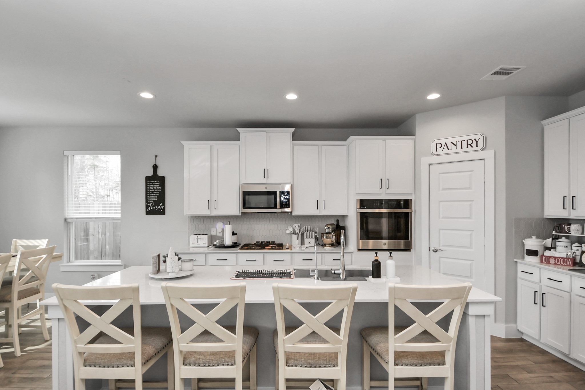 1920 Golden Spruce Lane Conroe, TX 77301 - Photo 13 of 28 a kitchen with stainless steel appliances kitchen island granite countertop a refrigerator a stove a sink a dining table and chairs