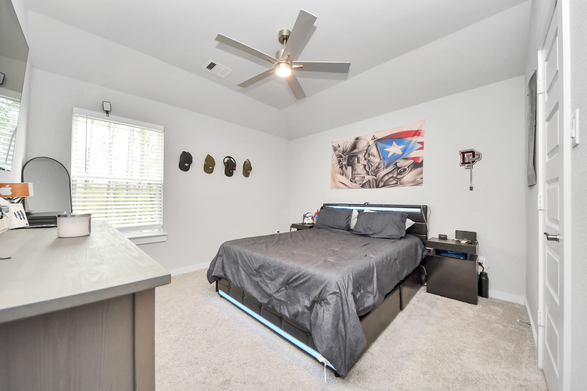 1920 Golden Spruce Lane Conroe, TX 77301 - Photo 24 of 28 a bedroom with a large bed and a chandelier