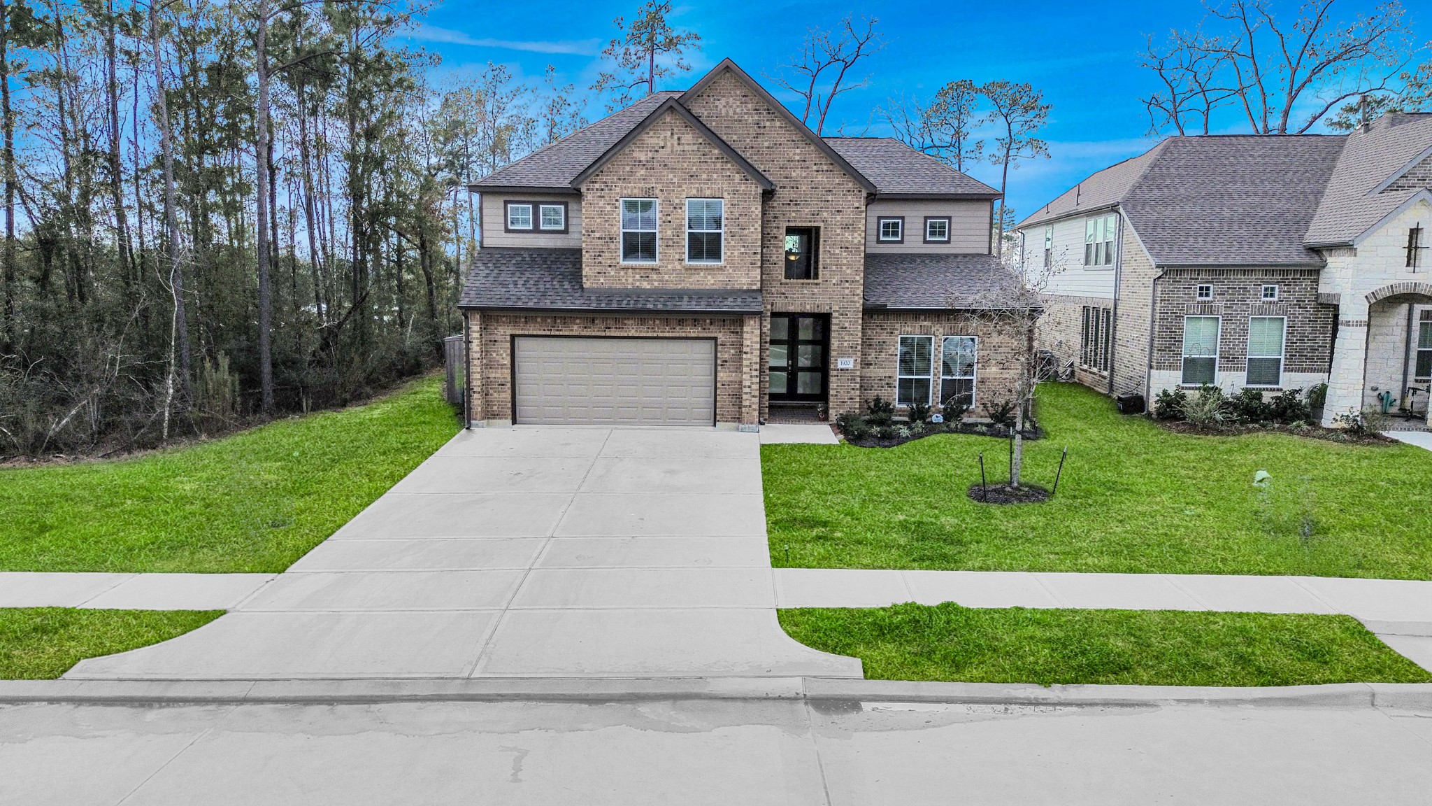 1920 Golden Spruce Lane Conroe, TX 77301 - Photo 4 of 28 a front view of a house with a yard and garage