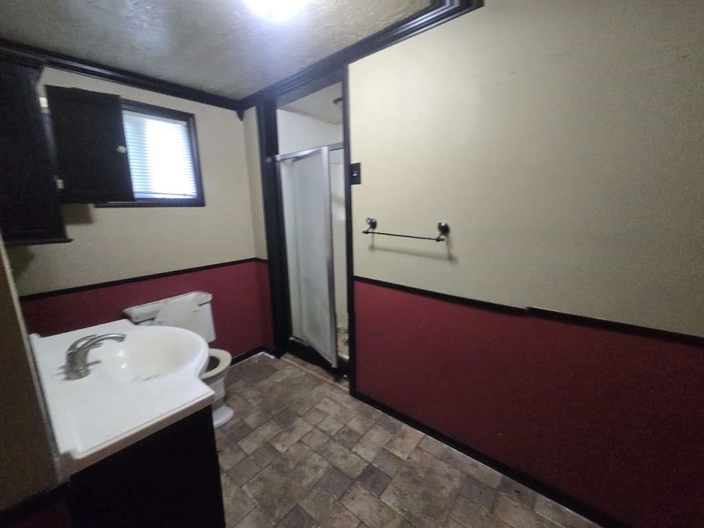 208 South 6th Street Highlands, TX 77562 - Photo 12 of 12 a bathroom with a sink and a mirror
