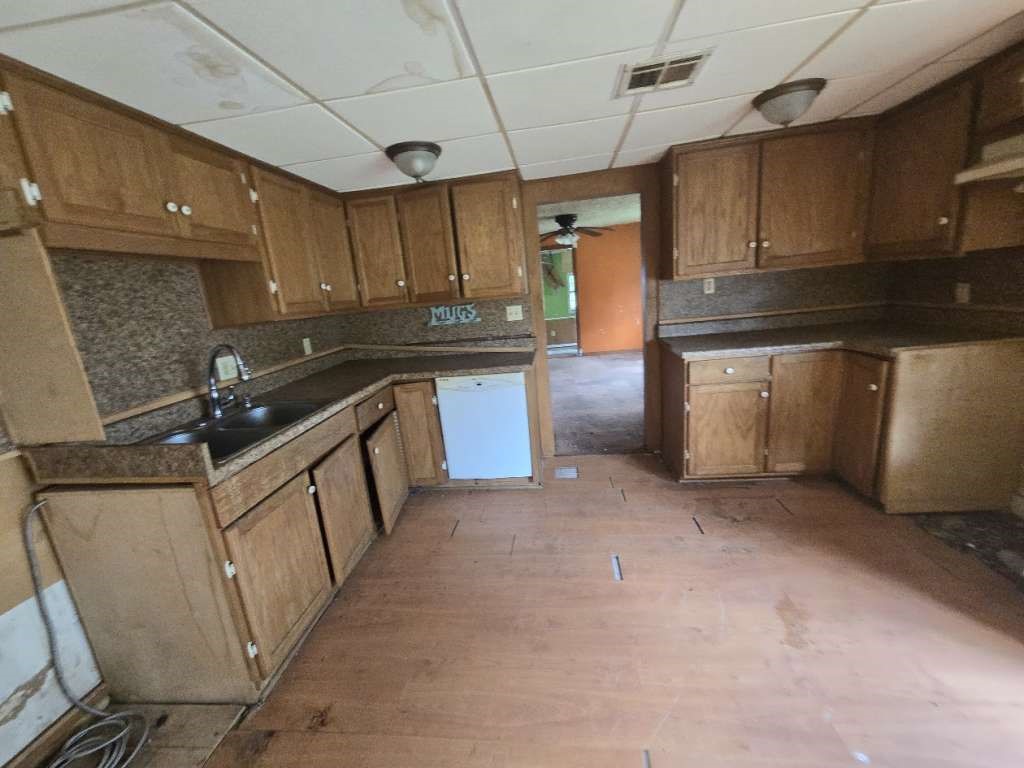 208 South 6th Street Highlands, TX 77562 - Photo 4 of 12 a kitchen with sink cabinets and window