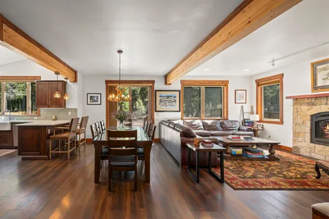 a living room with fireplace furniture and a wooden floor