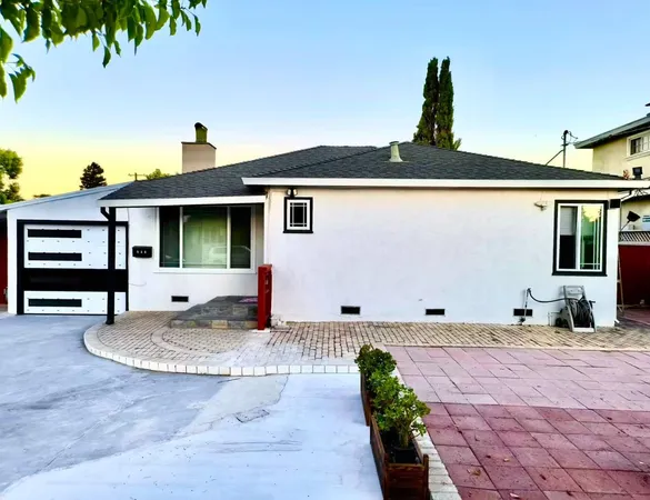a front view of a house with a garden