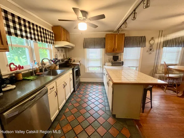 a kitchen with stainless steel appliances granite countertop a sink a stove and a refrigerator