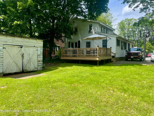 a front view of a house with a garden and yard