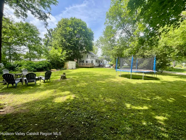 a view of a backyard with swimming pool