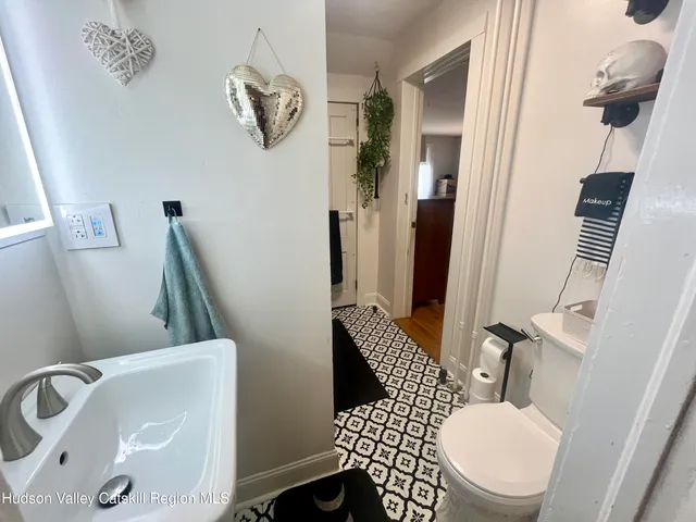 a bathroom with a sink a toilet and mirror