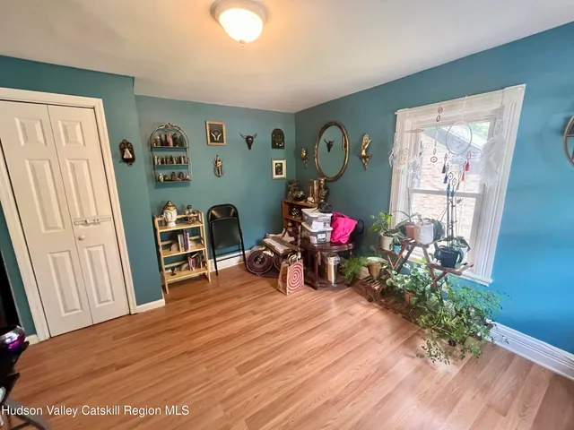 a view of a livingroom with furniture hardwood floor and a window