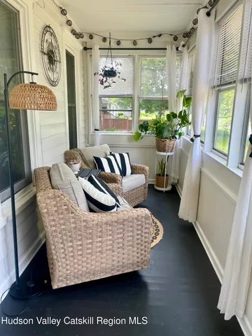 a living room with furniture window and wooden floor