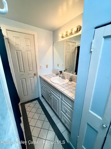 a bathroom with a sink a mirror and a shower