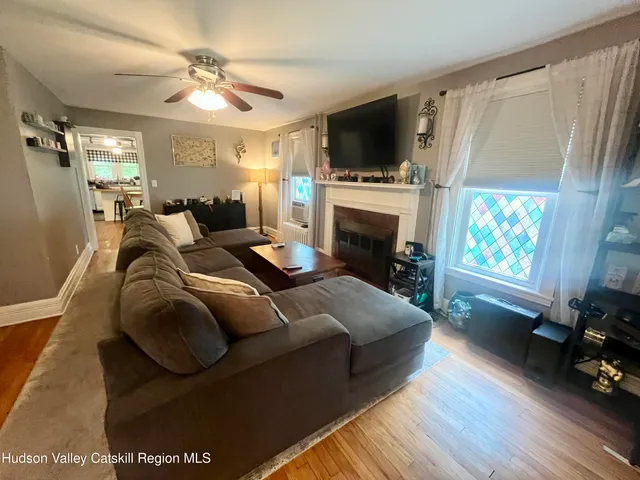a spacious bedroom with a bed a chandelier and a fireplace