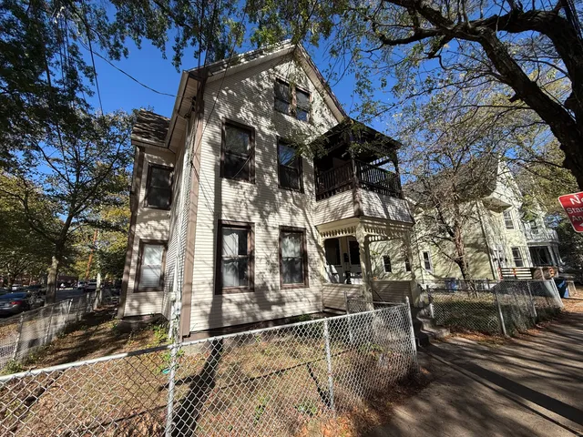 a view of a house with a tree