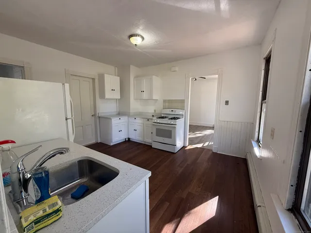 a kitchen with a sink and a refrigerator
