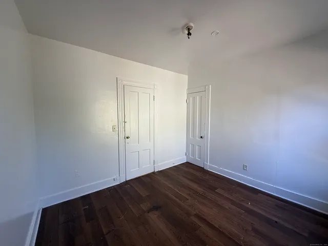 a view of room with wooden floor