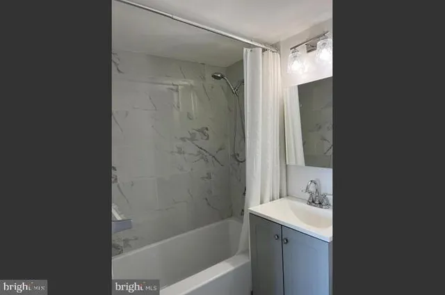 a bathroom with a shower and a sink