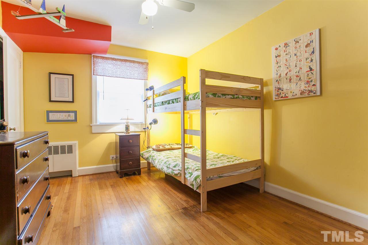 2509 Pickett Road Durham, NC 27705 - Photo 13 of 25 a bedroom with a bed and wooden floor