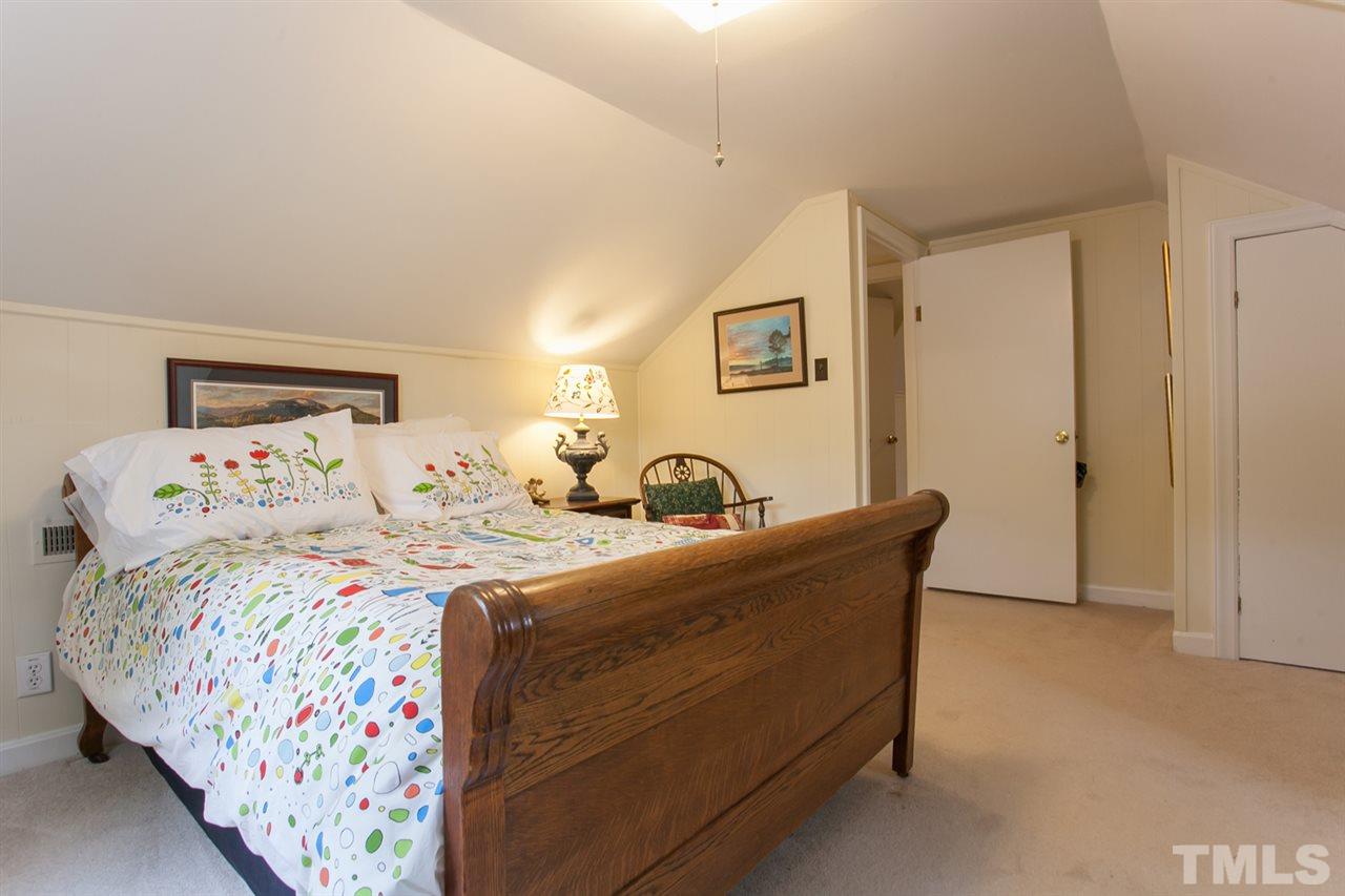 2509 Pickett Road Durham, NC 27705 - Photo 15 of 25 a bed room with large bed and a couch